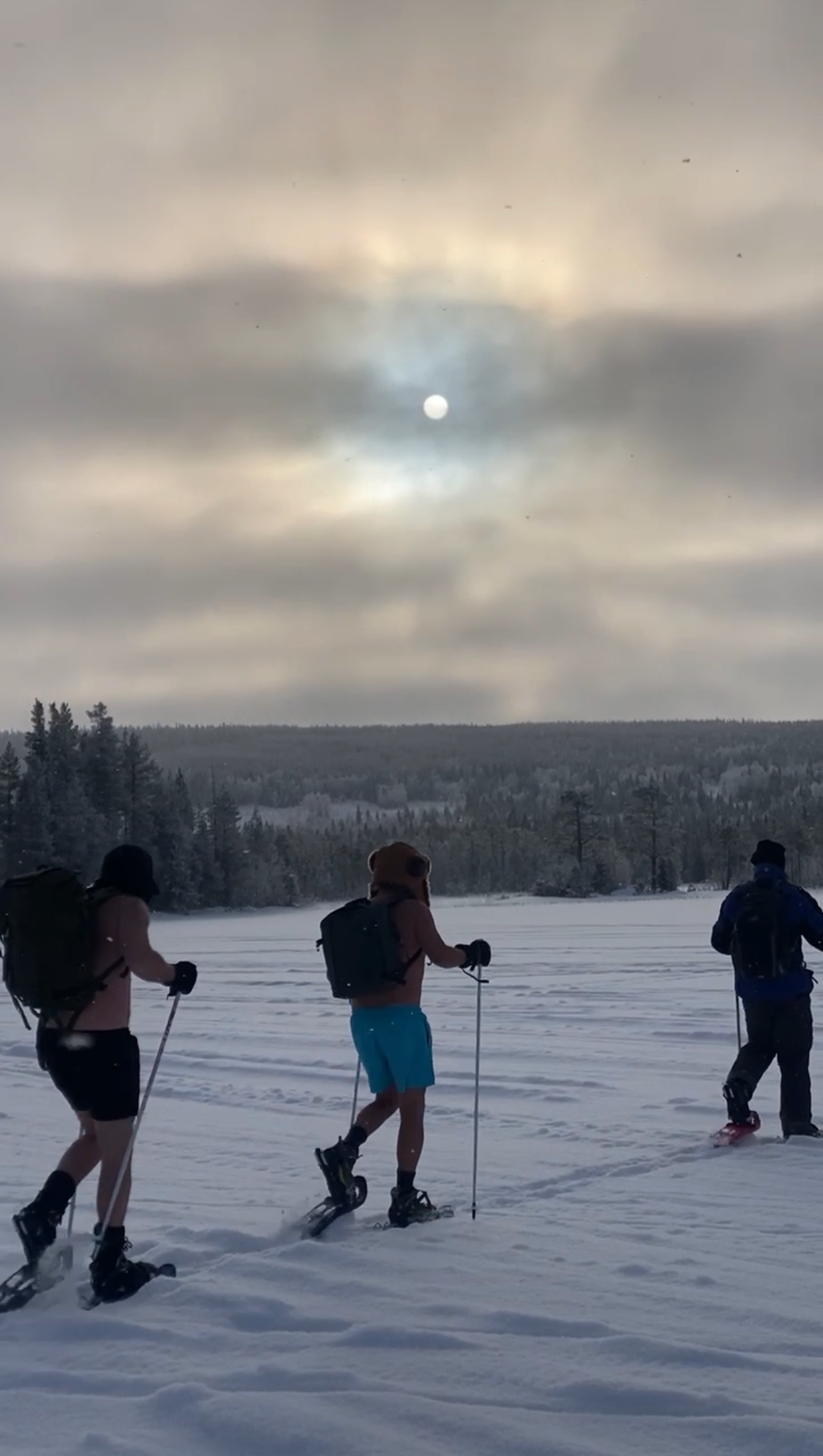 Snowshoe hiking through the winter landscape of Northern Sweden
